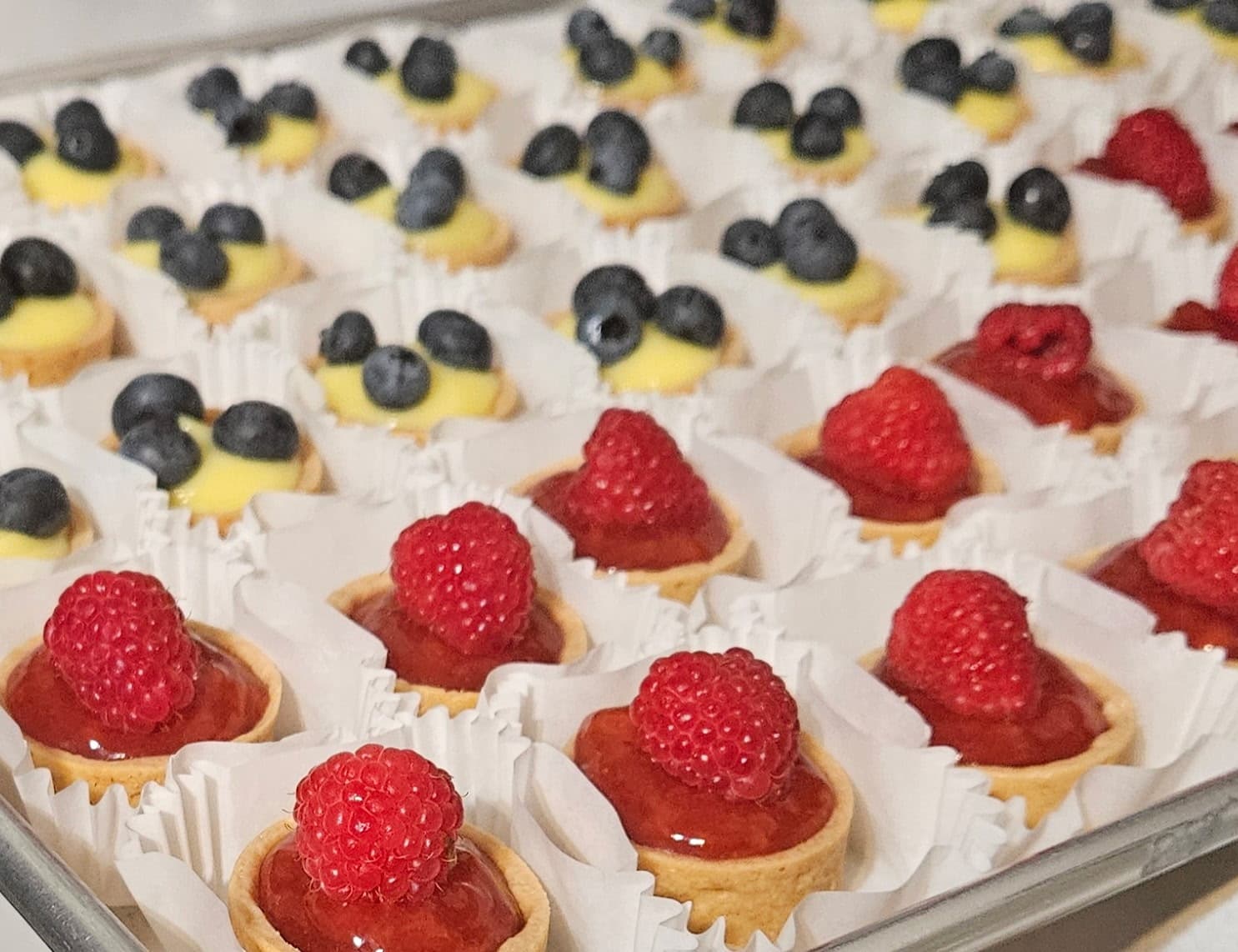 Trays of fruit tarts prepared for an event