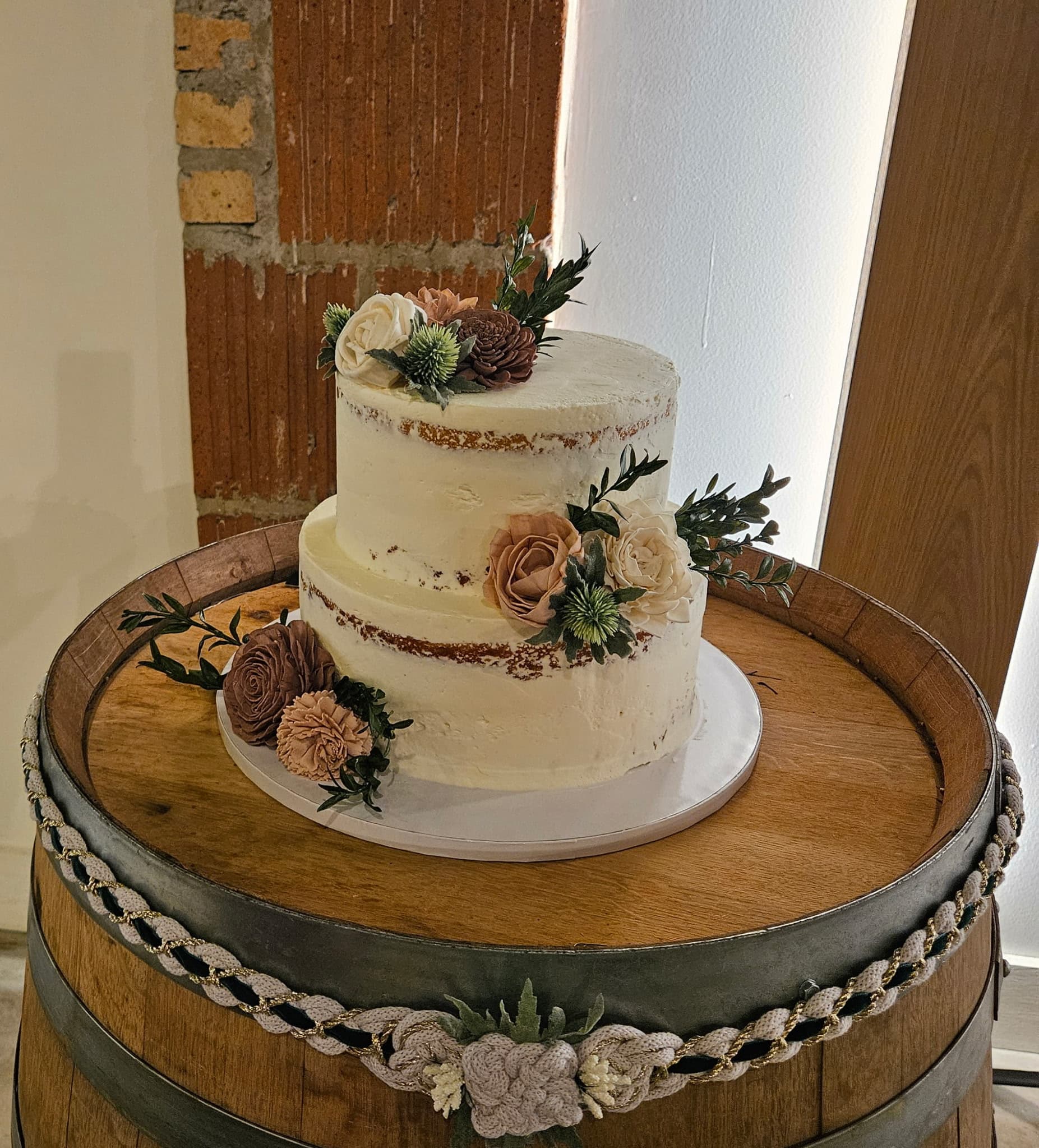 Two-tier buttercream wedding cake with dried florals